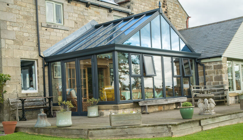 Grey gable conservatory with a glass roof