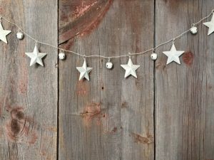 Stars and bells on a on a wooden background.