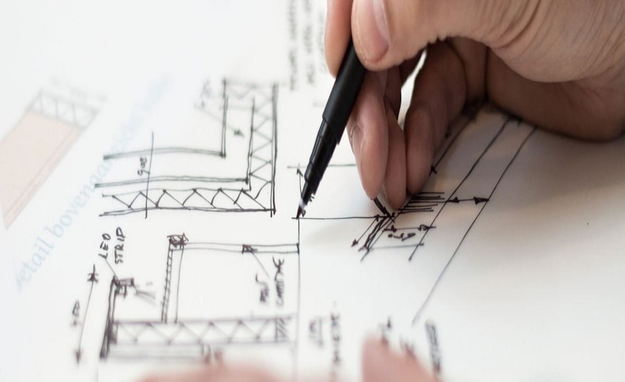 Architect drawing and writing up plans
