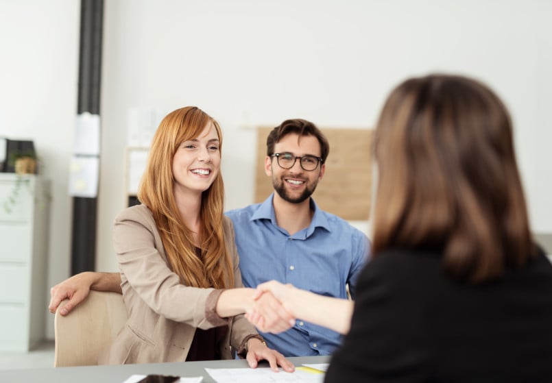 A couple getting a quote from a home improvement expert.