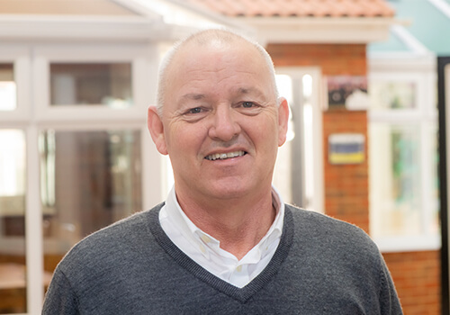 Steve James with a grey jumper on.