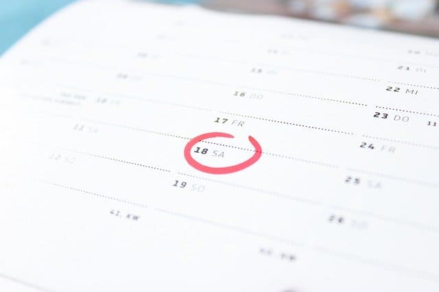 Red circle on date on wall calendar.