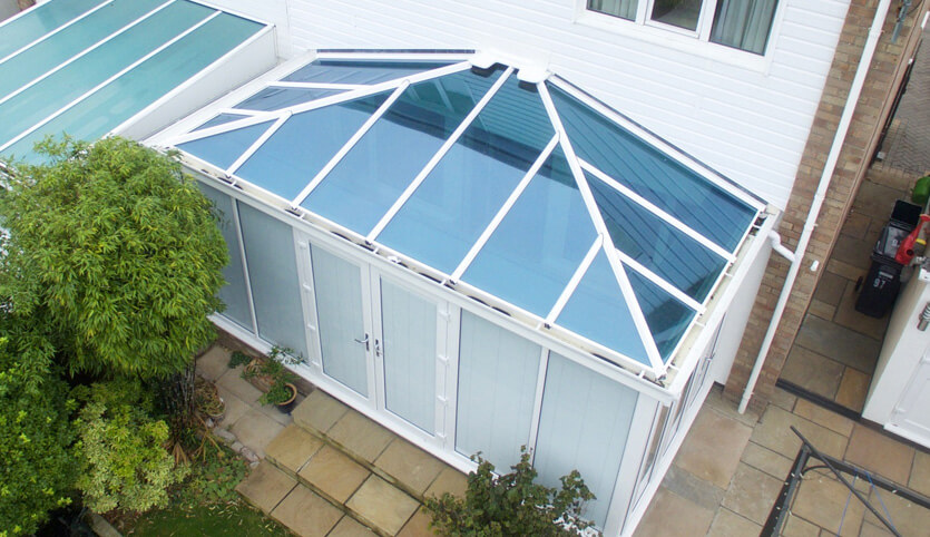 A Edwardian conservatory with a glass roof.