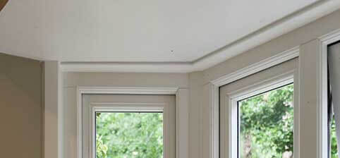 A head jam which is The first horizontal bar that forms the top of the window frame.