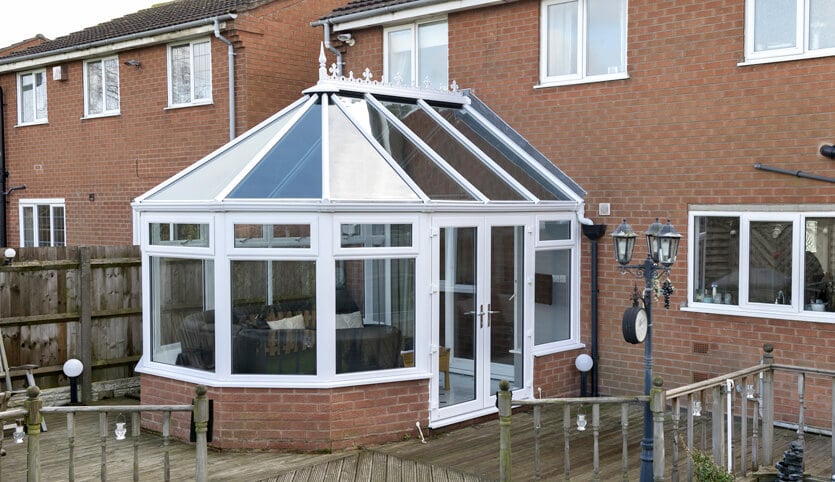 White uPVC Victorian conservatory with a glass roof