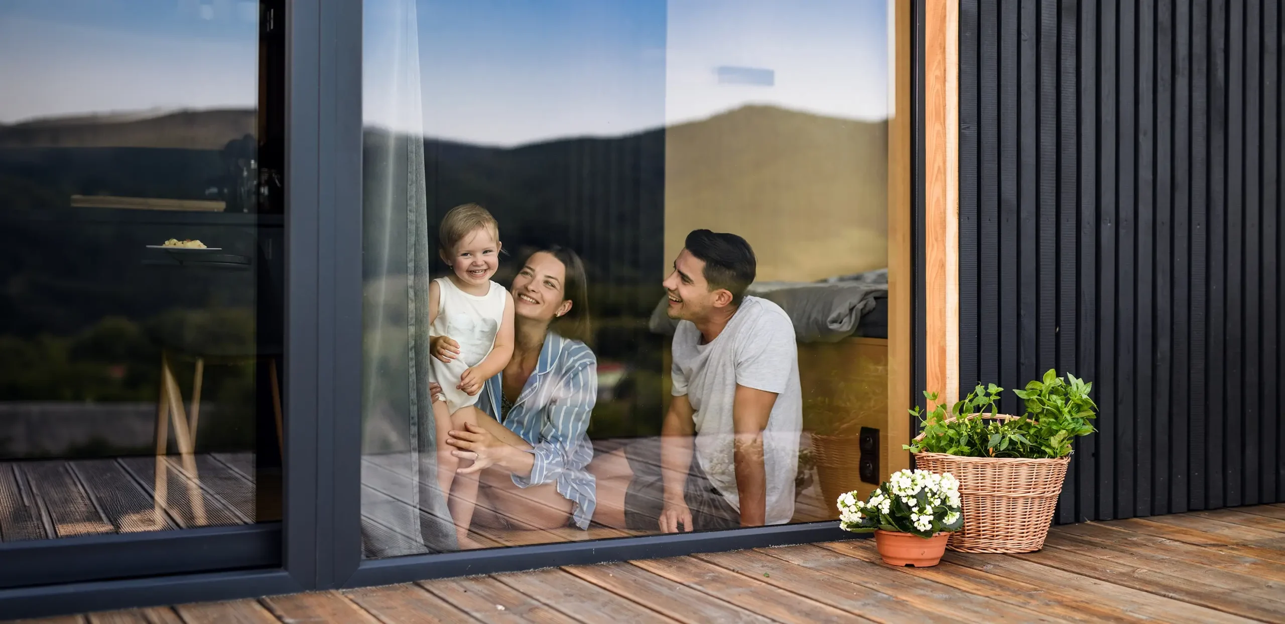 Family sitting at large window looking out