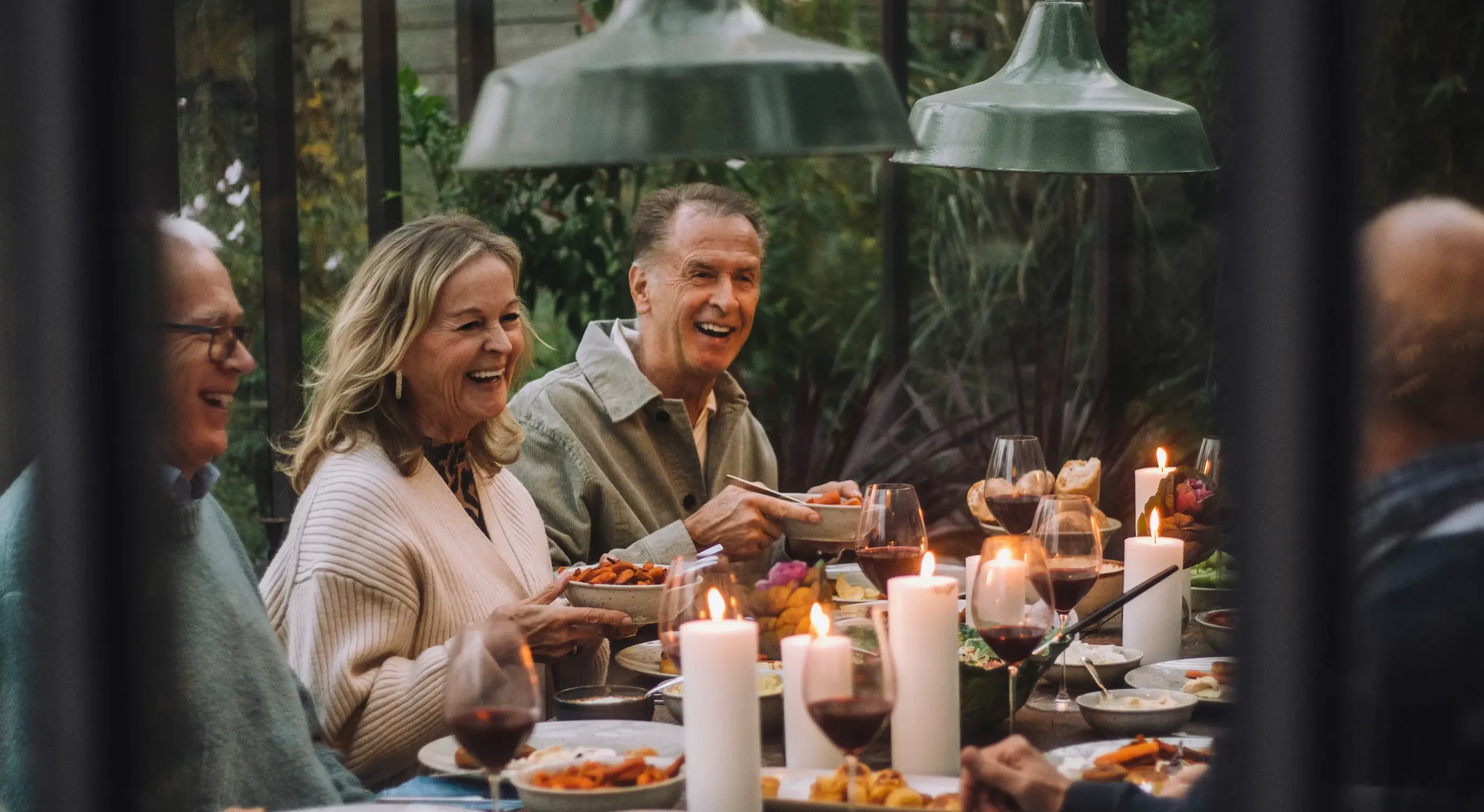 Happy group eating dinner around a table